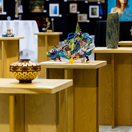 fine craft pieces displayed on wooden pedestals